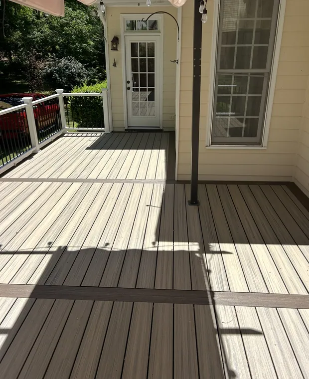 Two tone composite deck with a white rail and black balusters