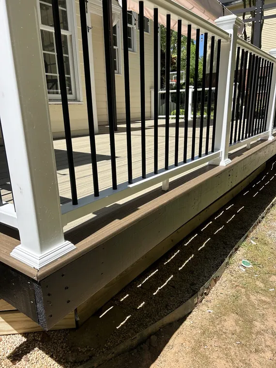Composite decking with a white rail and black metal balusters