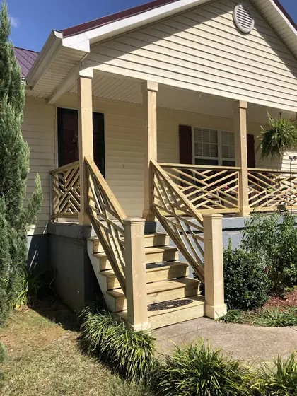 Front porch with steps, railing and lattice detail