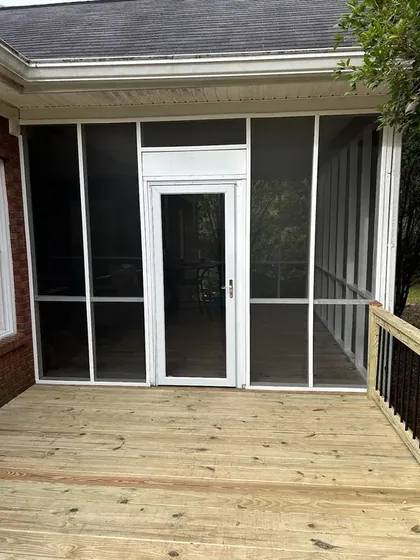 Screened porch opening onto a new wood deck