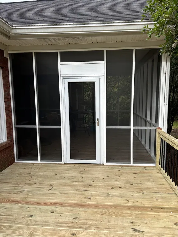 Screened porch opening onto a new wood deck