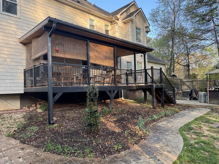 Covered deck with railing on a two storey home