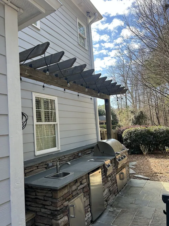 Pergola over an outdoor kitchen and grill area