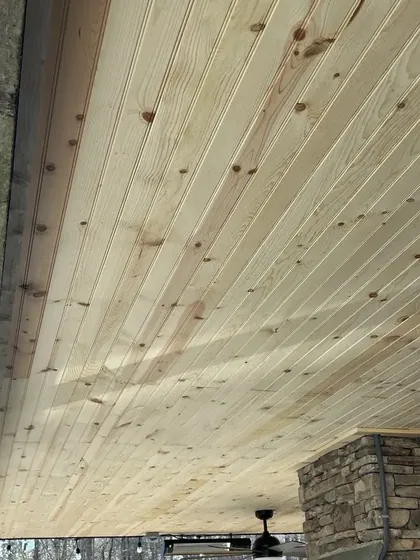 Wood plank ceiling installed on a covered porch