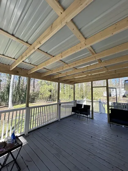 Underside of a covered porch with a finished deck floor