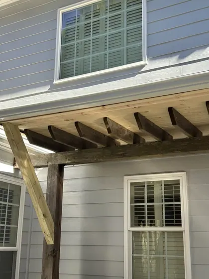 Pergola frame built onto the back of a house