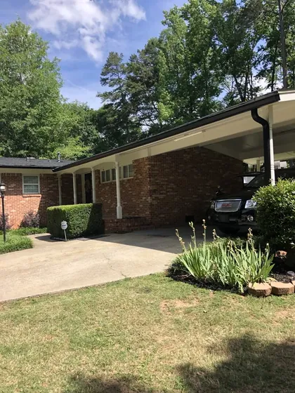 Rear of a home with a carport and drive